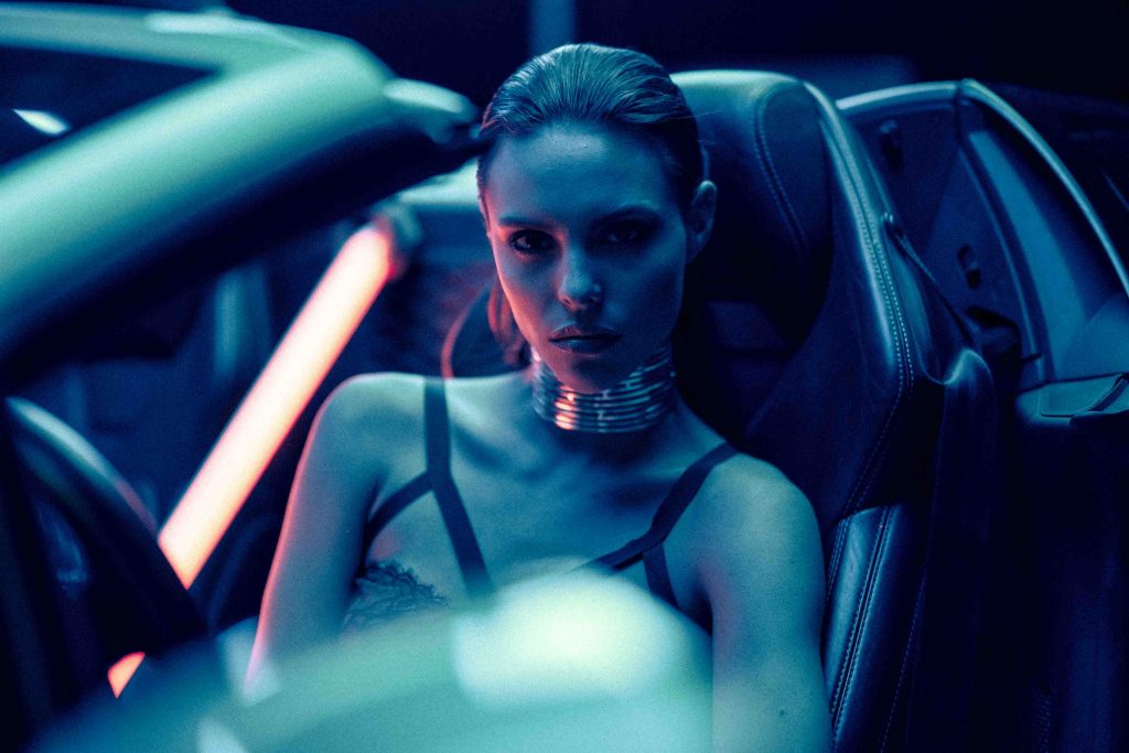 a model sits inside of a car during a chroma house video production company shoot